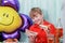 A 10-year-old boy eating a sweet berry pie.On a blue - blue background, close-up. Boy, young, child, desserts, candy, cookies, hap