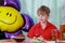 A 10-year-old boy eating a sweet berry pie.On a blue - blue background, close-up. Boy, young, child, desserts, candy, cookies, hap