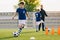 10 year old boy running soccer ball. Elementary age school kids on football training with young coach. Children sports team