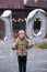 10 years birthday. the girl is holding large silver numbers one and zero. Cute joyful birthday girl with balloons