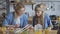 10 years old girl shows mom posts on a social network. Mom and daughter watch with a smartphone during lunch and have