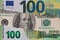 100 dollar banknote through torn Euro banknote
