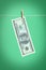 A 100 dollars banknote dries on a rope