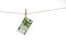 100 Euro banknote hanging on clothesline on white background.