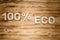 100 percent ECO words made of wooden block letters on wooden board