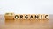 100 percent organic symbol. Fliped wooden cubes and changed words `organic` to `100 percent organic`. Beautiful wooden table,