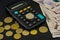 1000 hryvnia, calculator and coins on a black background. Close-up. Business concept. Coins with a face value of 2 hryvnia are on