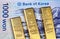 A 1000 South Korean won bank note with three gold bars close up