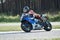 11-05-2020 Riga, Latvia. Motor biker on a race circuit speeding round a corner with a race circuit kerb behind