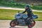 11-05-2020 Riga, Latvia. Motor biker on a race circuit speeding round a corner with a race circuit kerb behind