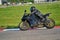 11-05-2020 Riga, Latvia. Motor biker on a race circuit speeding round a corner with a race circuit kerb behind