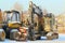 11.21.2020 Syktyvkar, Russia,forestry machinery harvestr and forwarder against the backdrop of a rustic winter landscape on a