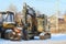 11.21.2020 Syktyvkar, Russia,forestry machinery harvestr and forwarder against the backdrop of a rustic winter landscape on a