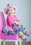 11 month old baby girl in pink dress-up clothes