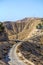 115/5000 Israel, Negev desert, View of a narrow mountain road through the negev desert with the vegetation on both sid