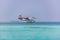 12.15.2015: Seaplane at tropical beach resort. Luxury summer travel destination with seaplane in Maldives islands