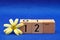 12 July on wooden blocks with a yellow flower