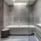 12 A modern, luxurious bathroom with a mix of marble and glass finishes, a large, freestanding bathtub, and a mix of open and cl