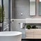 12 A modern, sleek bathroom with a mix of white and metallic finishes, a large, freestanding bathtub, and a mix of open and clos