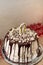 12 years birthday buffet. White cake with chocolate streaks and candles stay on table. Bat Mitzvah party. Vertical photo,