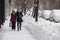 13.02.2021, Russia, Moscow. An elderly couple carefully walks along the pavement cleared after the snowfall.
