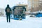 13.02.2021, Russia, Moscow. Passenger at a public transport stop. The city bus is coming.