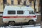 13-11-2020. Russia, Syktyvkar. White old russian ambulance brand UAZ with a red stripe with blue flashing lights on a city street