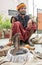 13.August.2021 Kanpur India, Snake Charmer sitting on the ground with Black Cobra in his wooden basket.