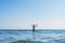 13 years old boy raises his hands standing up in the sea waves. Concept of family vacation