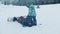 14-12-19 RUSSIA, KAZAN: Family snowboarding - A man with prosthetic leg teaching his son how to get on the snowboard