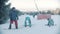 14-12-19 RUSSIA, KAZAN: Family snowboarding - A man with prosthetic leg watching his kids trying to get on the snowboard