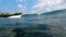 14 September 2019 , Balangan Beach, Bali ; Man surfing wave as seen from the water on a perfect sunny day - Activity/sports and le