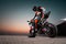 15.10.20, California, USA. The driver in a motorcycle jacket and helmet is sitting on a sportbike, looking back. Rear view