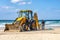 15/12/2018 Israel, Netanya, the driver of the excavator runs a bucket of manipulator, performs the repair of a public beach on a s