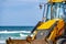 15/12/2018 Israel, Netanya, the driver of the excavator runs a bucket of manipulator, performs the repair of a public beach on a s