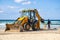 15/12/2018 Israel, Netanya, the driver of the excavator runs a bucket of manipulator, performs the repair of a public beach on a s