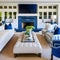 15 A beachy, coastal-inspired living room with a mix of blue and white upholstery, a large fireplace mantle with coastal decor,