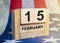 15 february inscription on wooden calendar with american flag background. President day in USA
