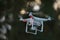 16 - Professional camera on a silver gimbal carried by a white drone