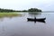 16 year old boy rowing a boat in Lake Saimaa, Finland