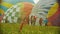 18-07-2019 Pereslavl-Zalessky, Russia: huge colorful air balloons lying on the field - people walking around and