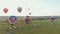 18-07-2019 Suzdal, Russia: different air balloons are taking off over the field - cars and trucks standing on the field