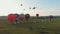 18-07-2019 Suzdal, Russia: different colorful air balloons are taking off over the field - cars and trucks standing on