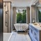 18 A transitional-style bathroom with a mix of traditional and modern elements, such as a clawfoot tub and contemporary lighting