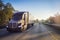 18 wheeler semi truck on highway with sun lens flare