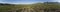 180 degree aerial panorama of village, farms, and mountains in Kyrgyzstan