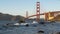 180p slow motion clip of waves breaking on rocks in front of golden gate bridge