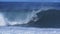 A 180p slow motion shot of a surfer getting a cover up at pipeline on the island of oahu in hawaii