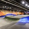182 A contemporary urban skate park with sleek ramps, vibrant street art, and a vibrant atmosphere, attracting skateboarders and