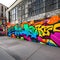 1852 Urban Graffiti Wall: A vibrant and urban background featuring a graffiti-covered wall with street art, vibrant colors, and